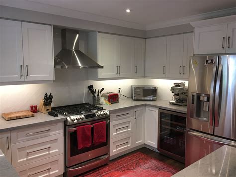 galley white cabinets stainless steel appliances|kitchens with white cabinets.